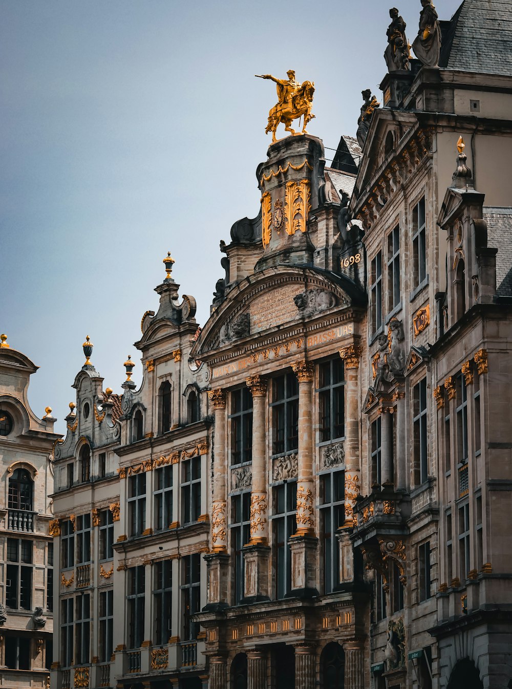 a large building with a golden statue on top of it