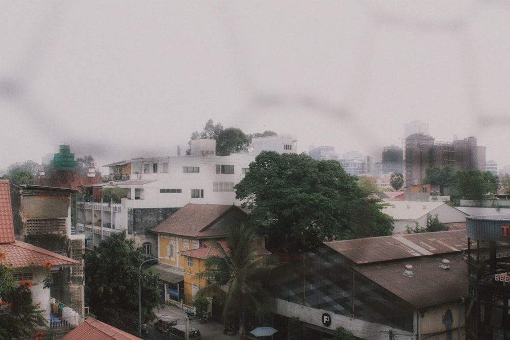 a view of a city through a fence