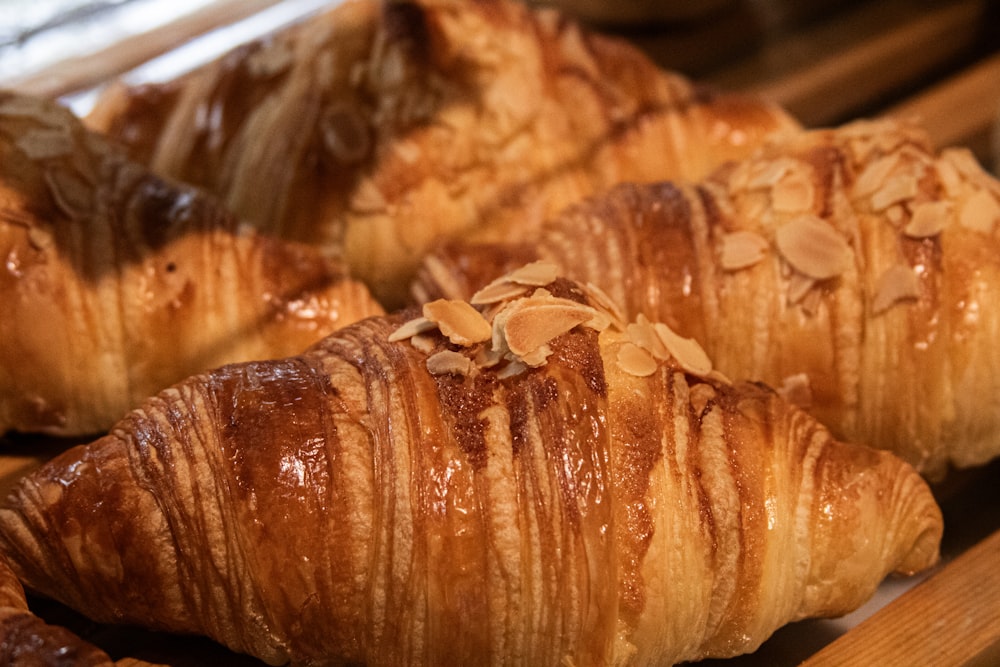 croissants with almonds on top of them on a tray