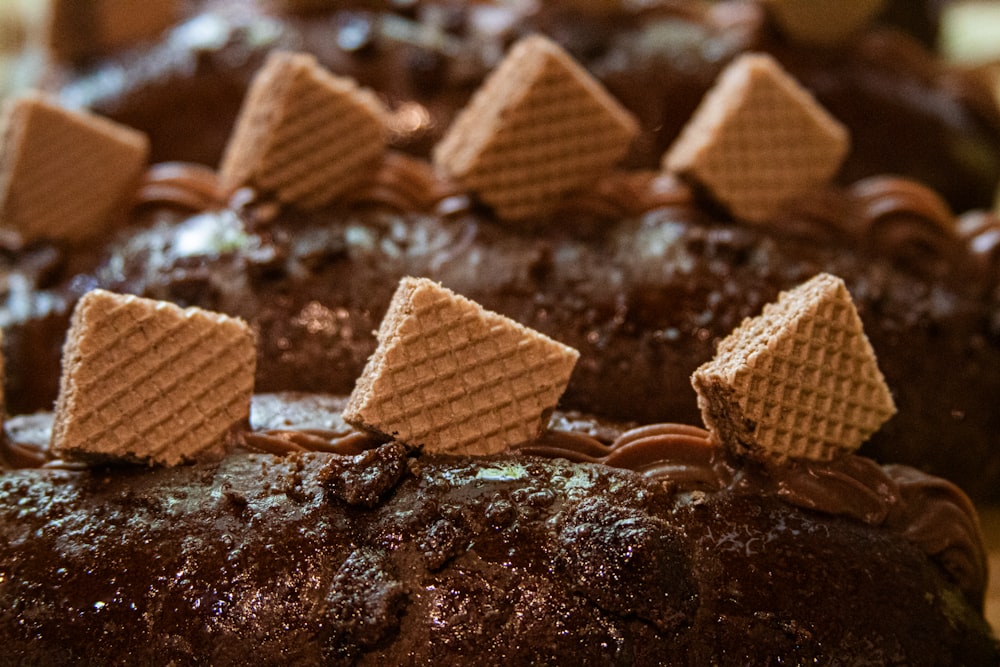 a close up of a chocolate cake with waffles on top