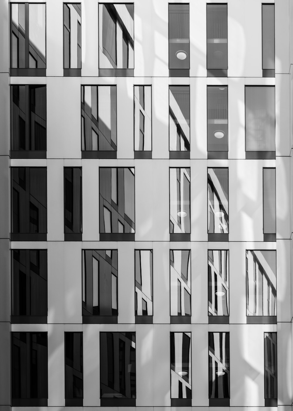 a black and white photo of a building with many windows