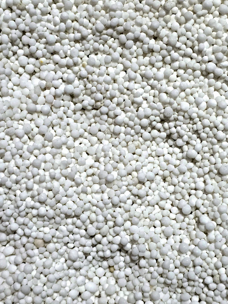 Close-up of white prilled inorganic fertilizer granules