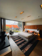 a bedroom with a large bed sitting next to a window