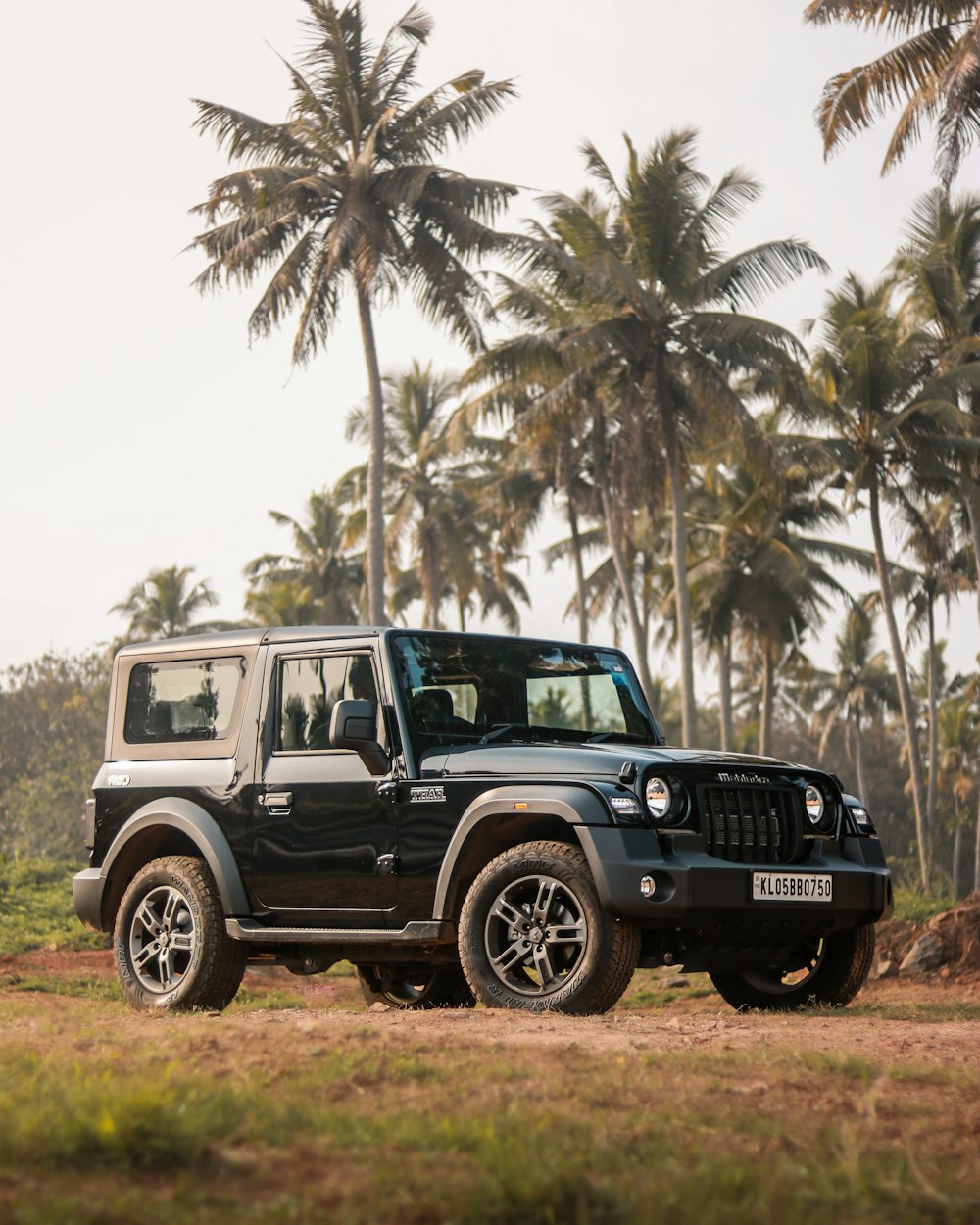 a black jeep parked on a dirt road