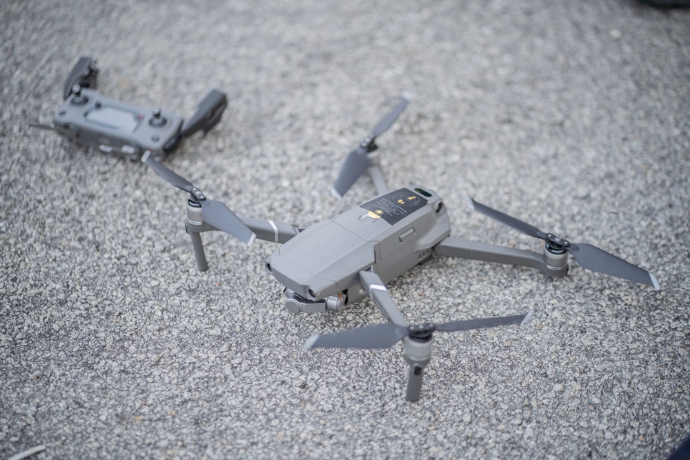 a small gray and black remote controlled flying device