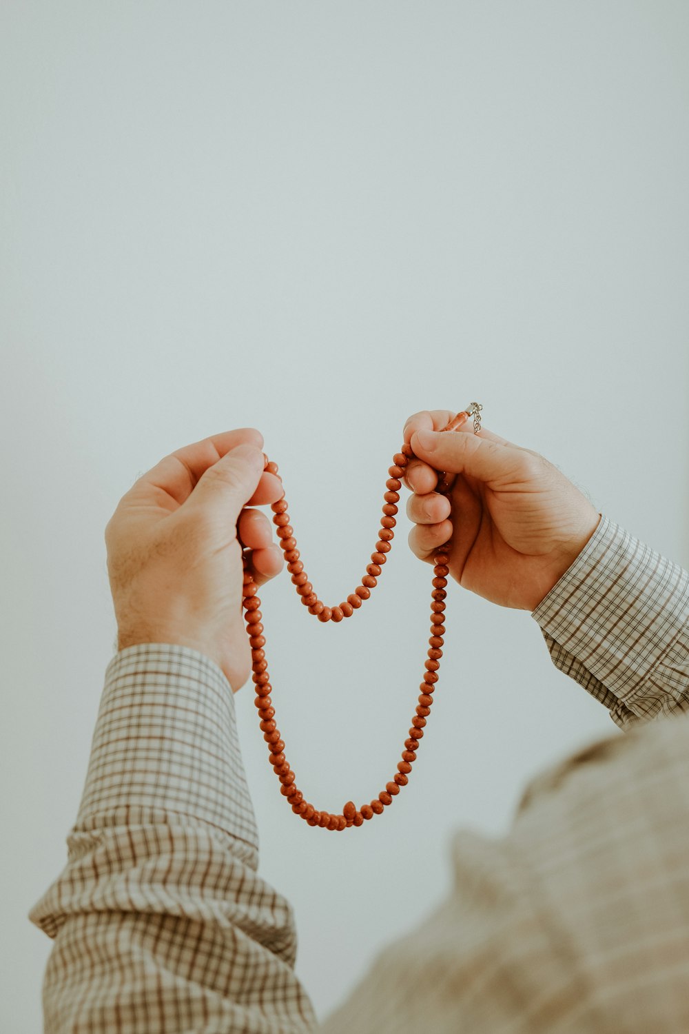 a person holding a rosary in their hands