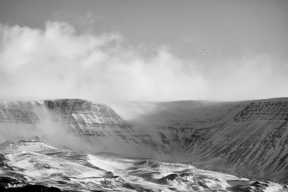 a black and white photo of a snow covered mountain