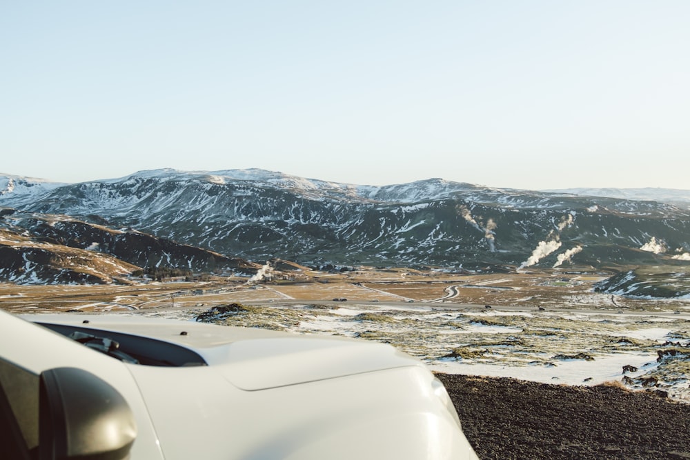 a white truck parked on top of a snow covered mountain