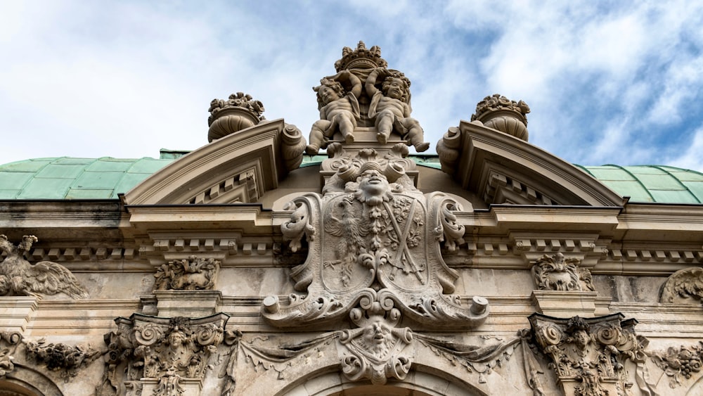 a building with a green roof and a statue on top of it