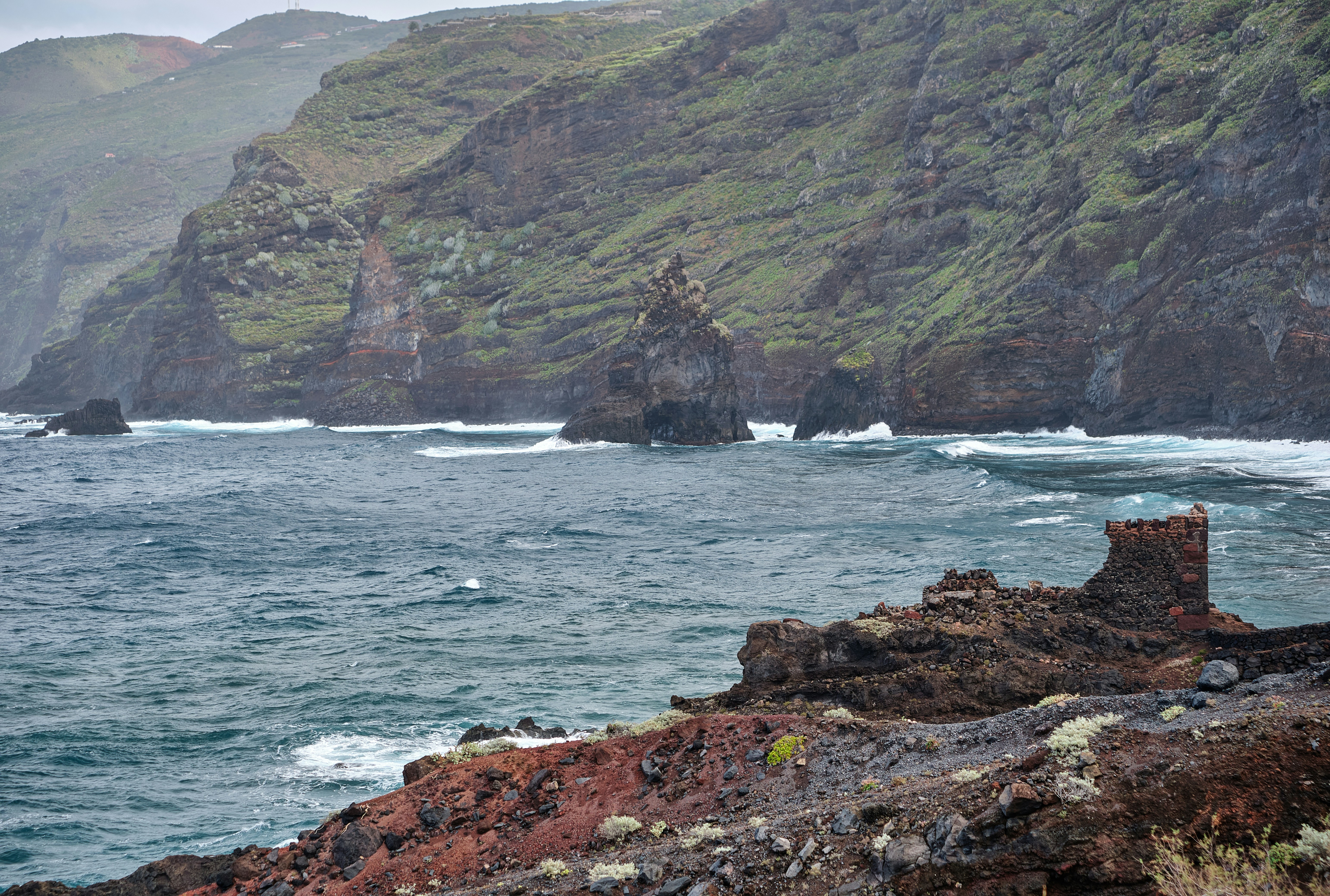 a large body of water near a rocky shore