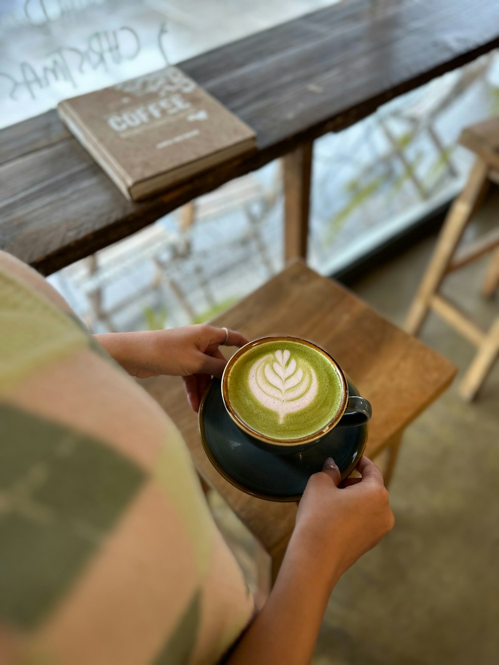 a person is holding a cup of coffee