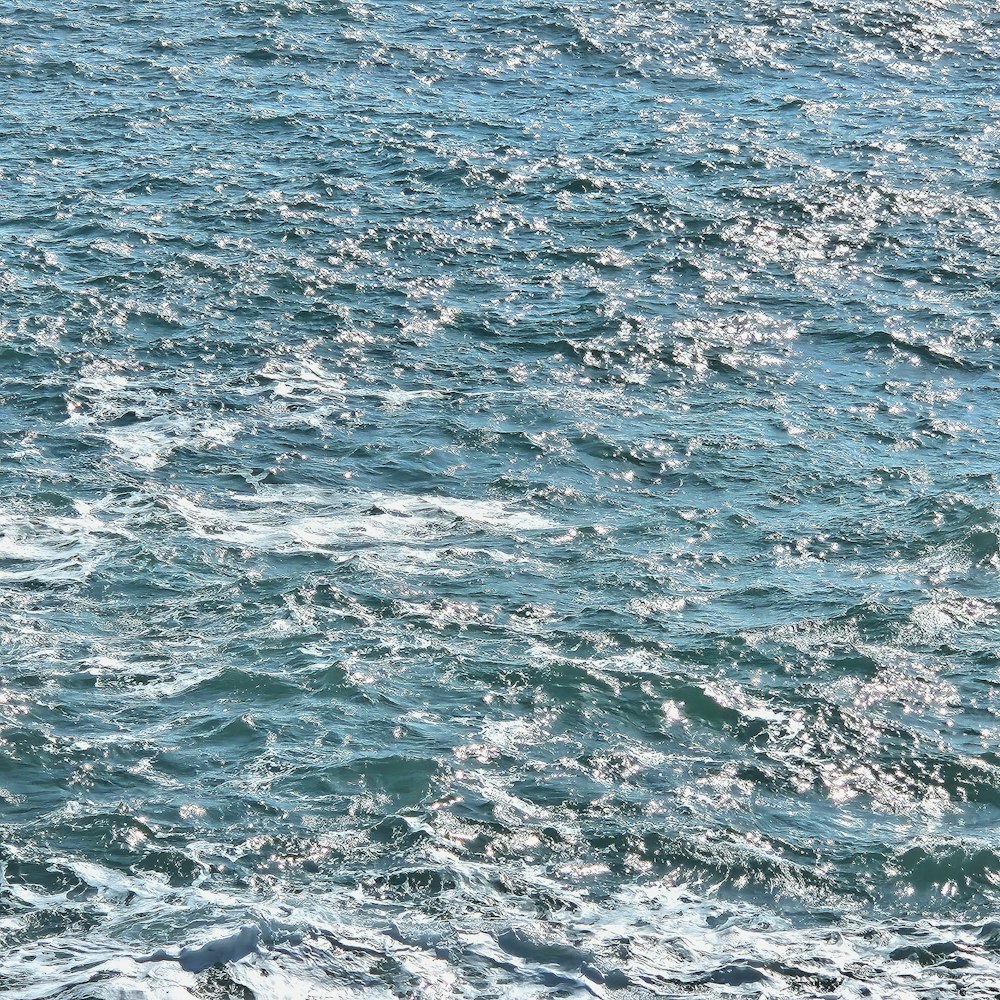 a man riding a surfboard on top of a body of water