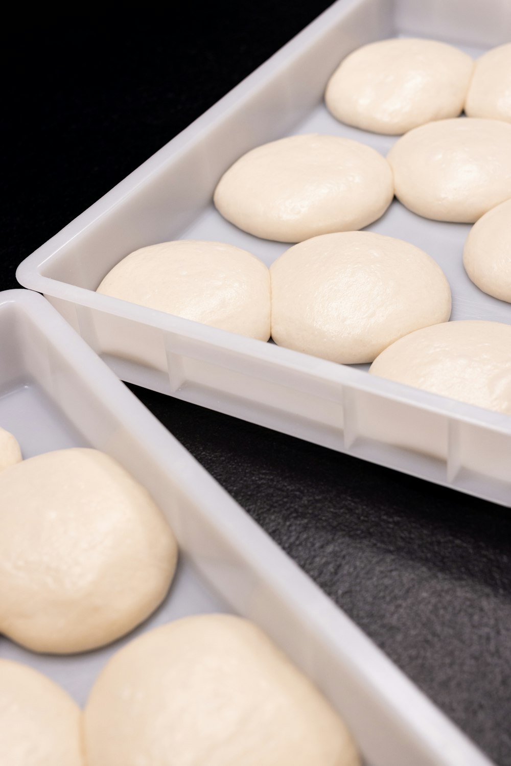 a couple of pans filled with doughnuts on top of a table