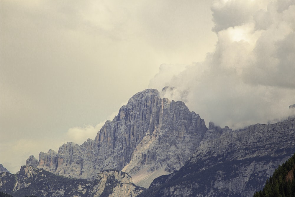 a mountain range with a few clouds in the sky