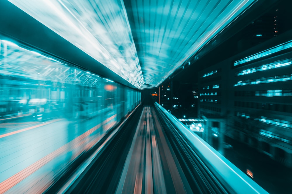 a blurry photo of a train going through a tunnel