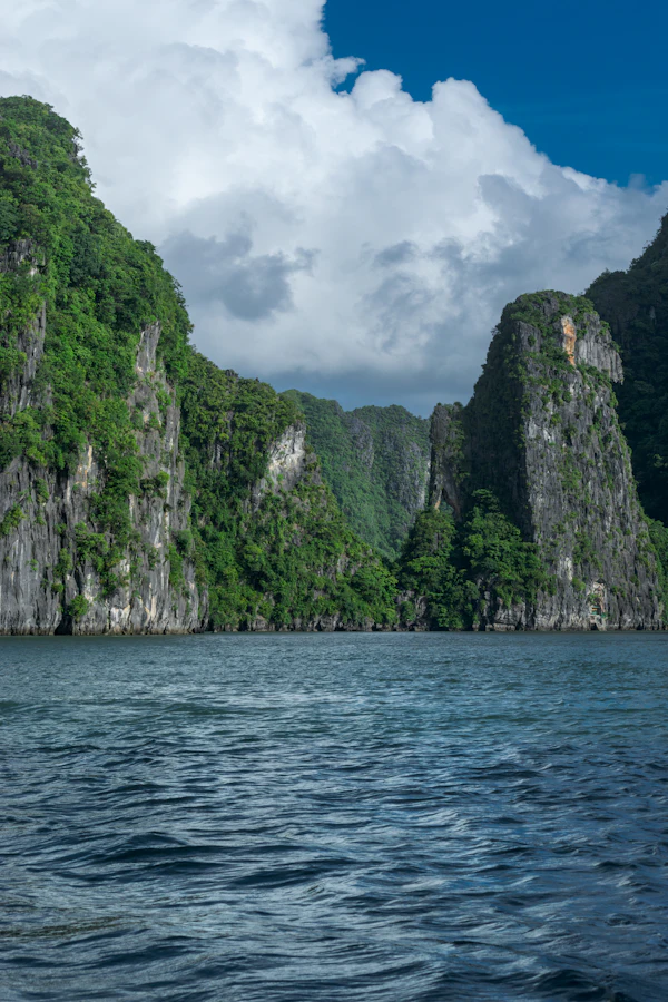 Clouds above limestone islands and water in Ha Long Bay