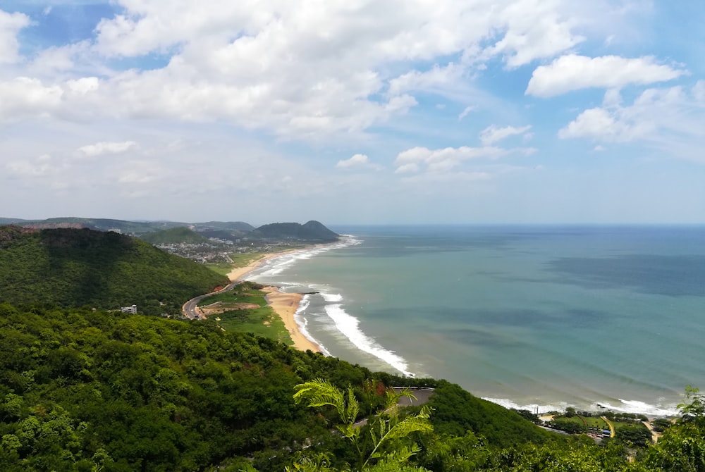 a view of a beach from a hill overlooking the ocean