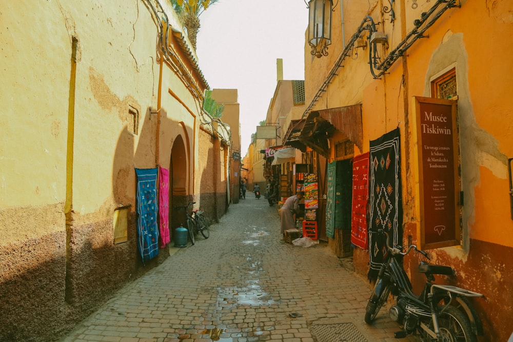 a narrow street with a bike parked on the side of it