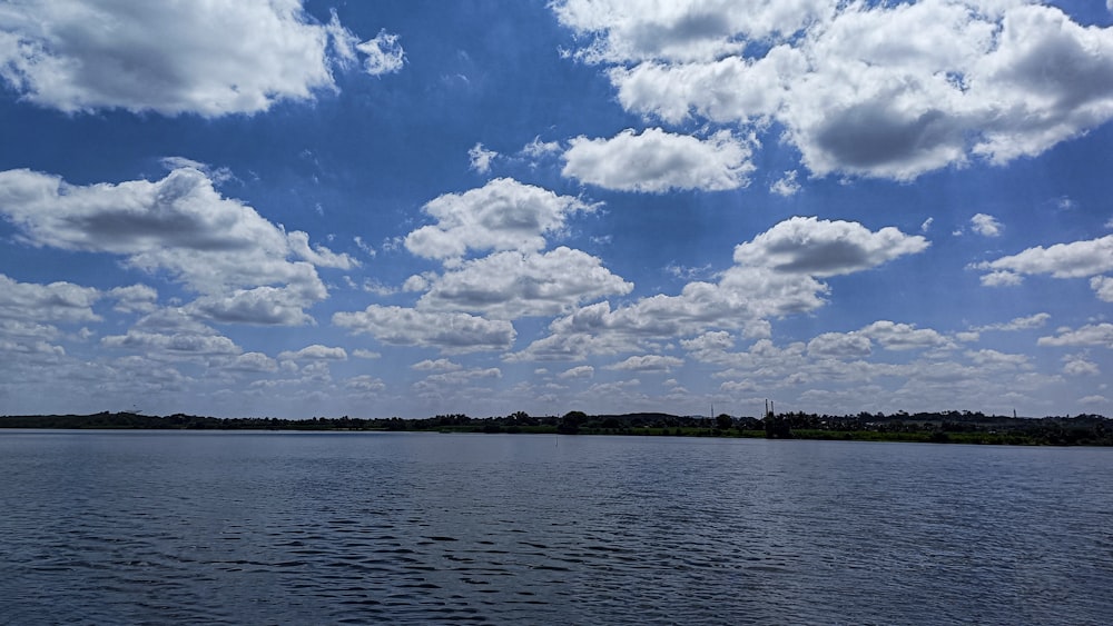 a large body of water with clouds in the sky