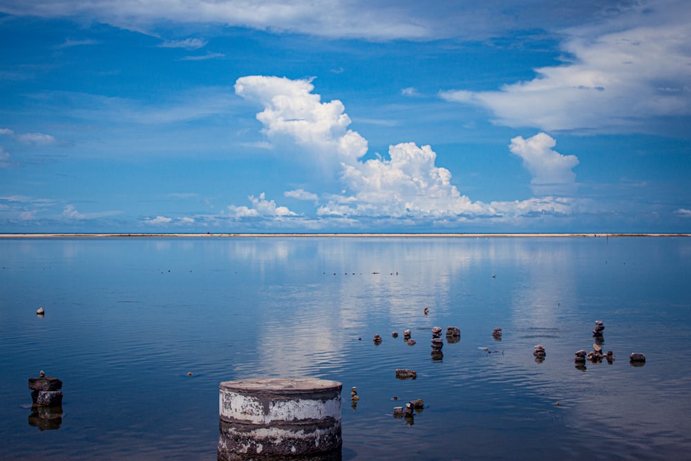 a large body of water with a sky in the background