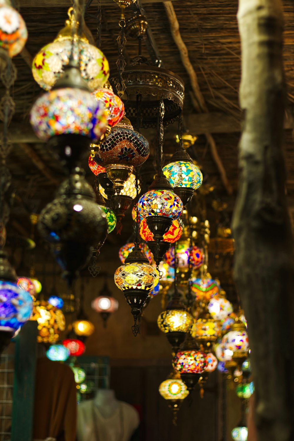 a bunch of colorful lights hanging from a ceiling