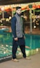 a man standing in front of a swimming pool