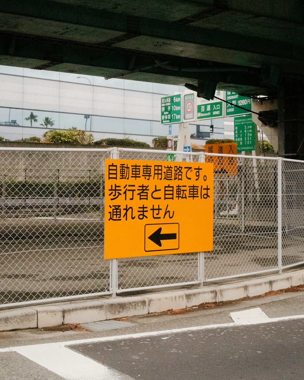 a yellow sign that is on the side of a road