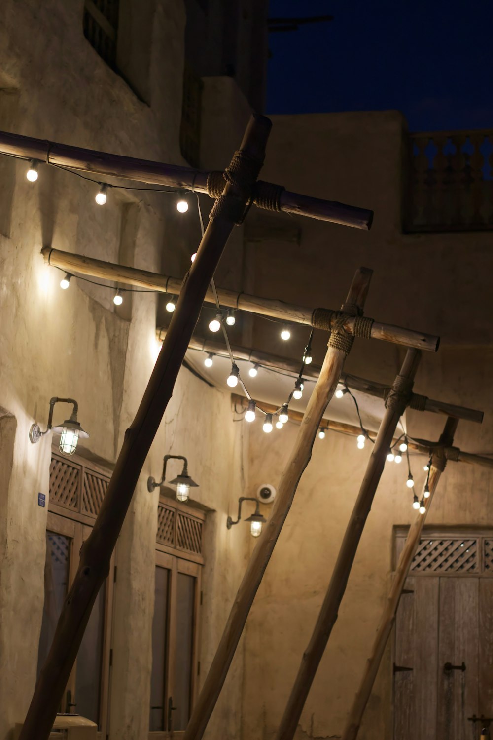 a row of lights hanging from the side of a building