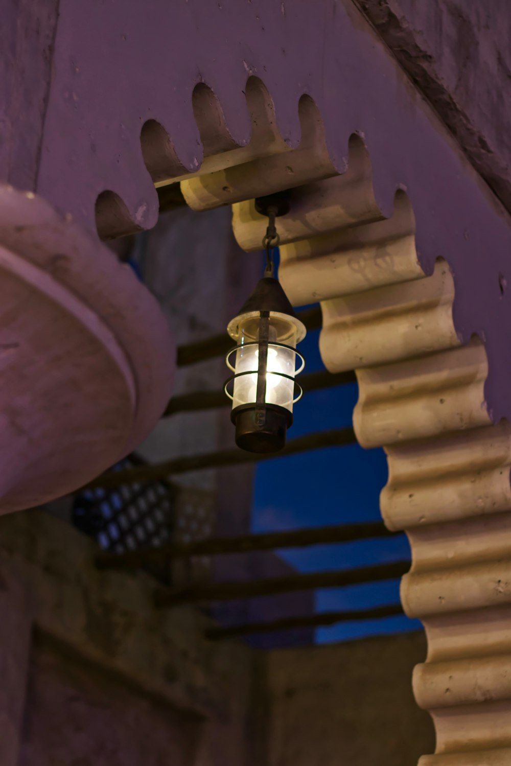 a lantern hanging from a ceiling in a building