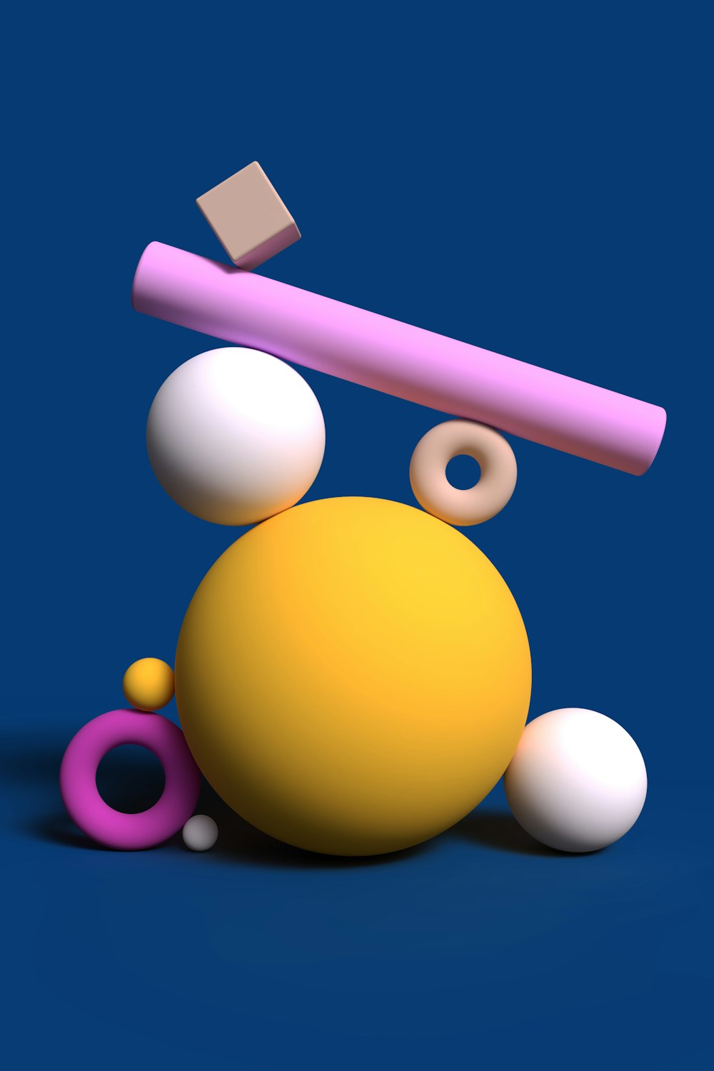 a yellow ball and a pink object on a blue background