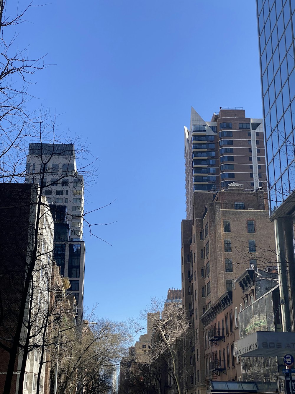 a view of a city street with tall buildings