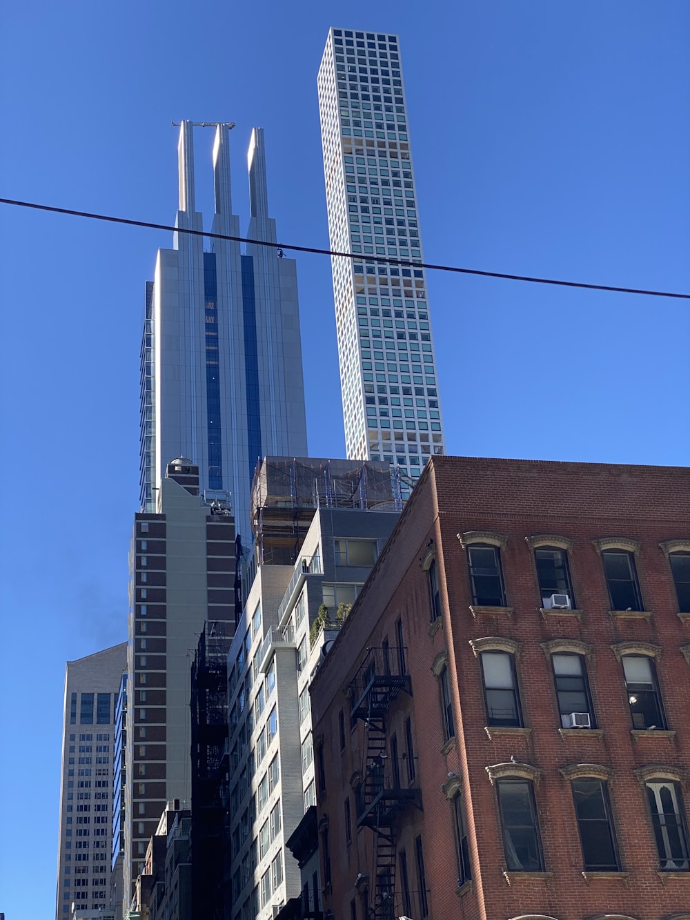 a city street with tall buildings in the background