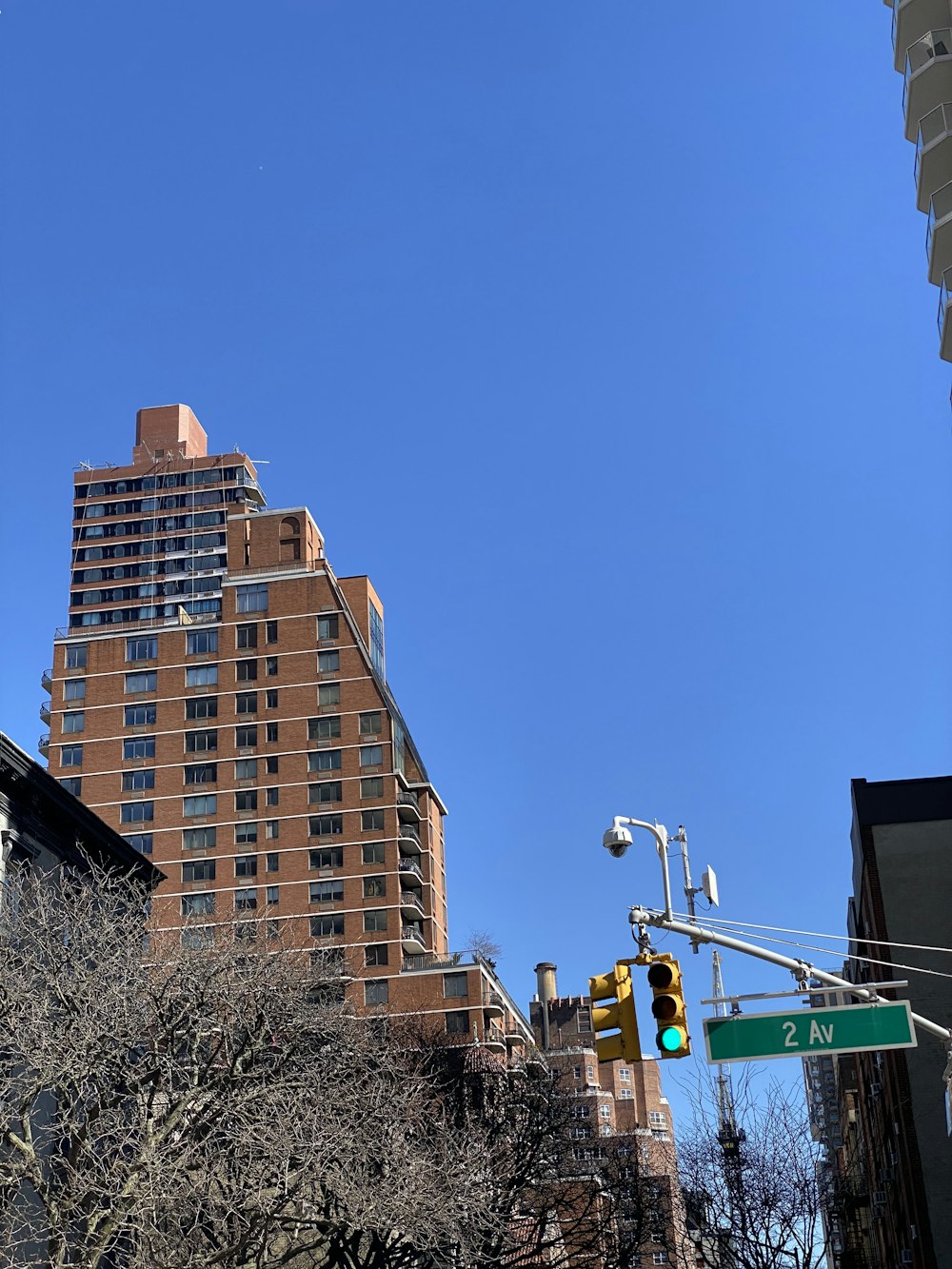 a traffic light on a city street with tall buildings in the background