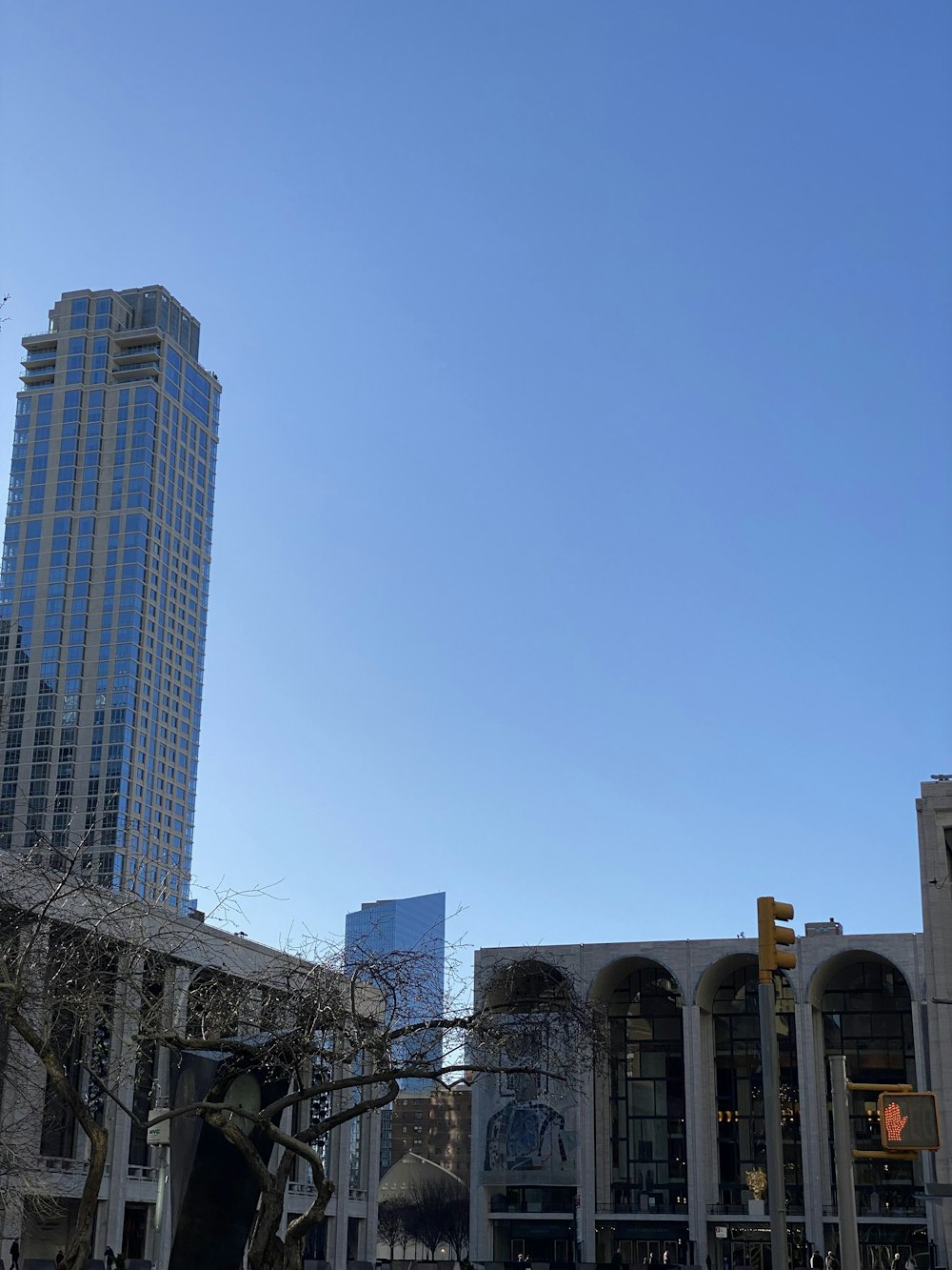 a clock tower towering over a city filled with tall buildings