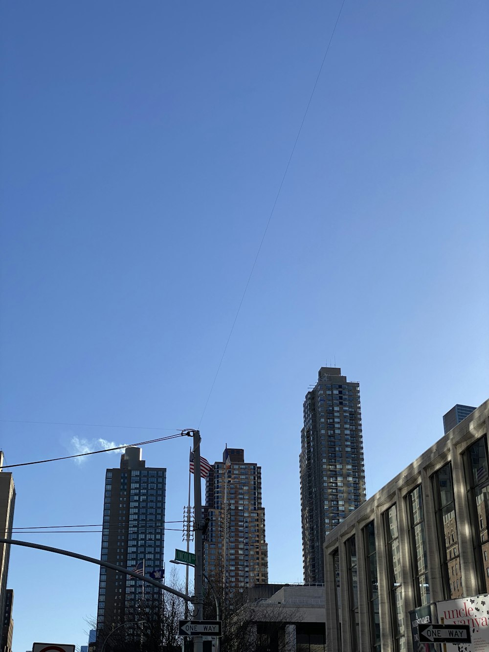 a city street with tall buildings and a traffic light