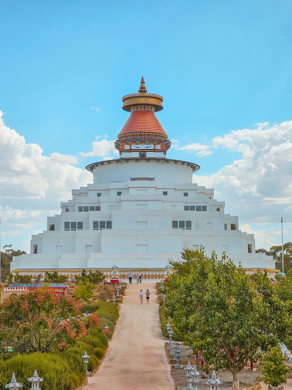 a large white building with a red dome on top of it