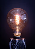 a light bulb sitting on top of a marble base