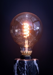 a light bulb sitting on top of a marble base