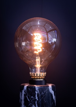 a light bulb sitting on top of a marble base