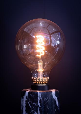 a light bulb sitting on top of a marble base