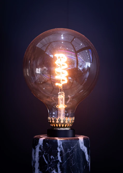 a light bulb sitting on top of a marble base