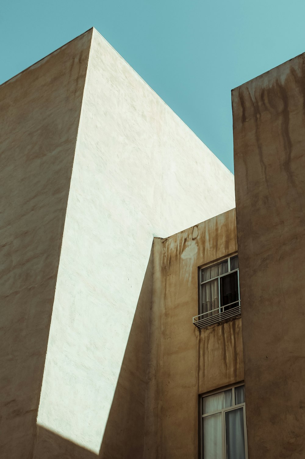 a tall building with a window and a balcony