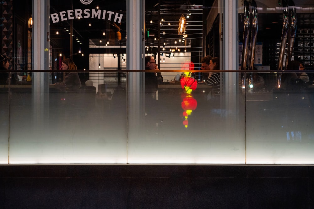 a reflection of a person sitting at a table in a restaurant