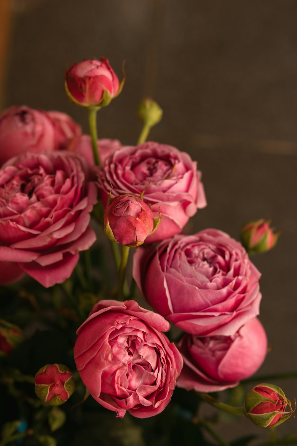 a vase filled with pink flowers on top of a table