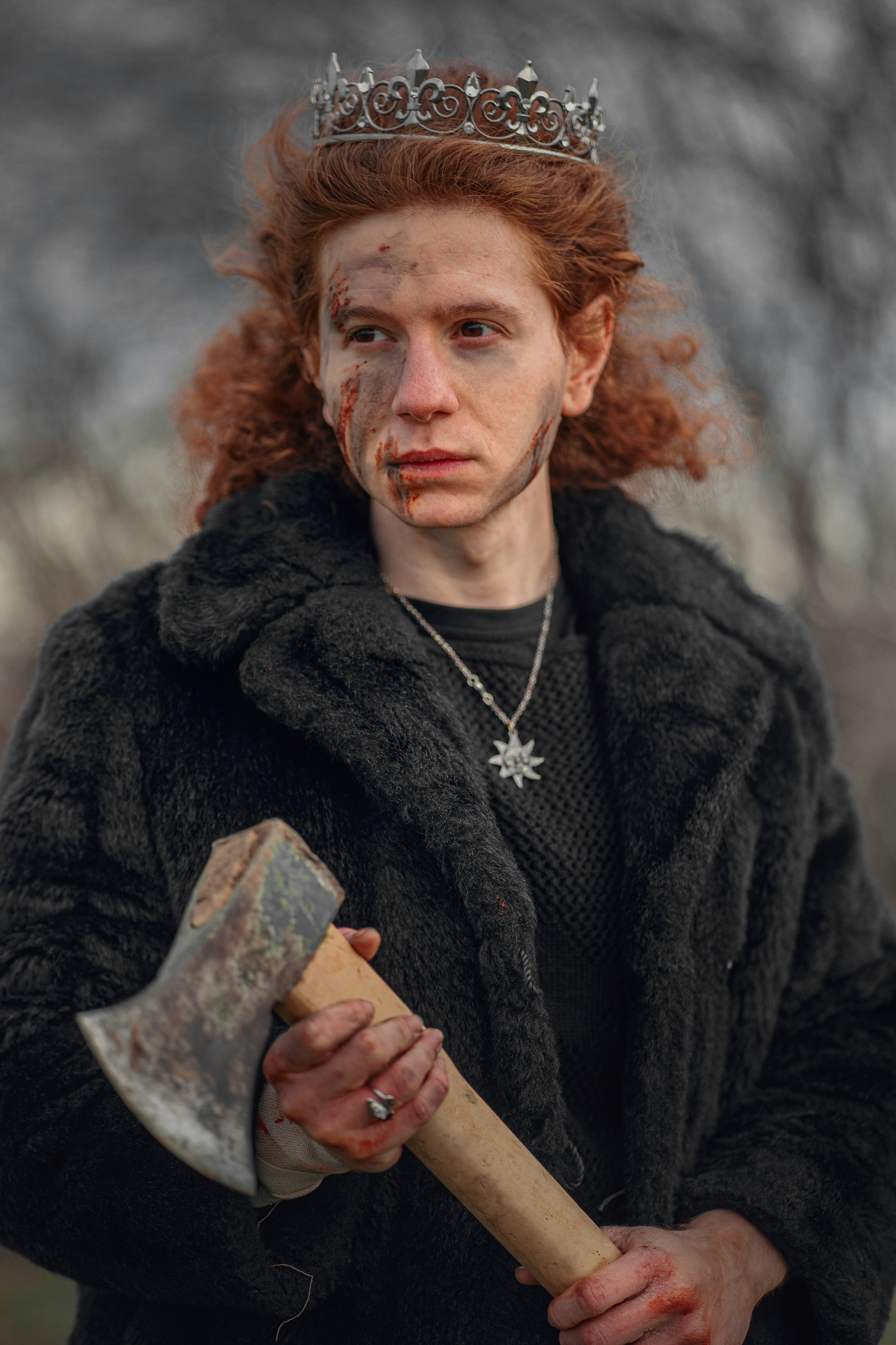a man with a crown on his head holding an axe