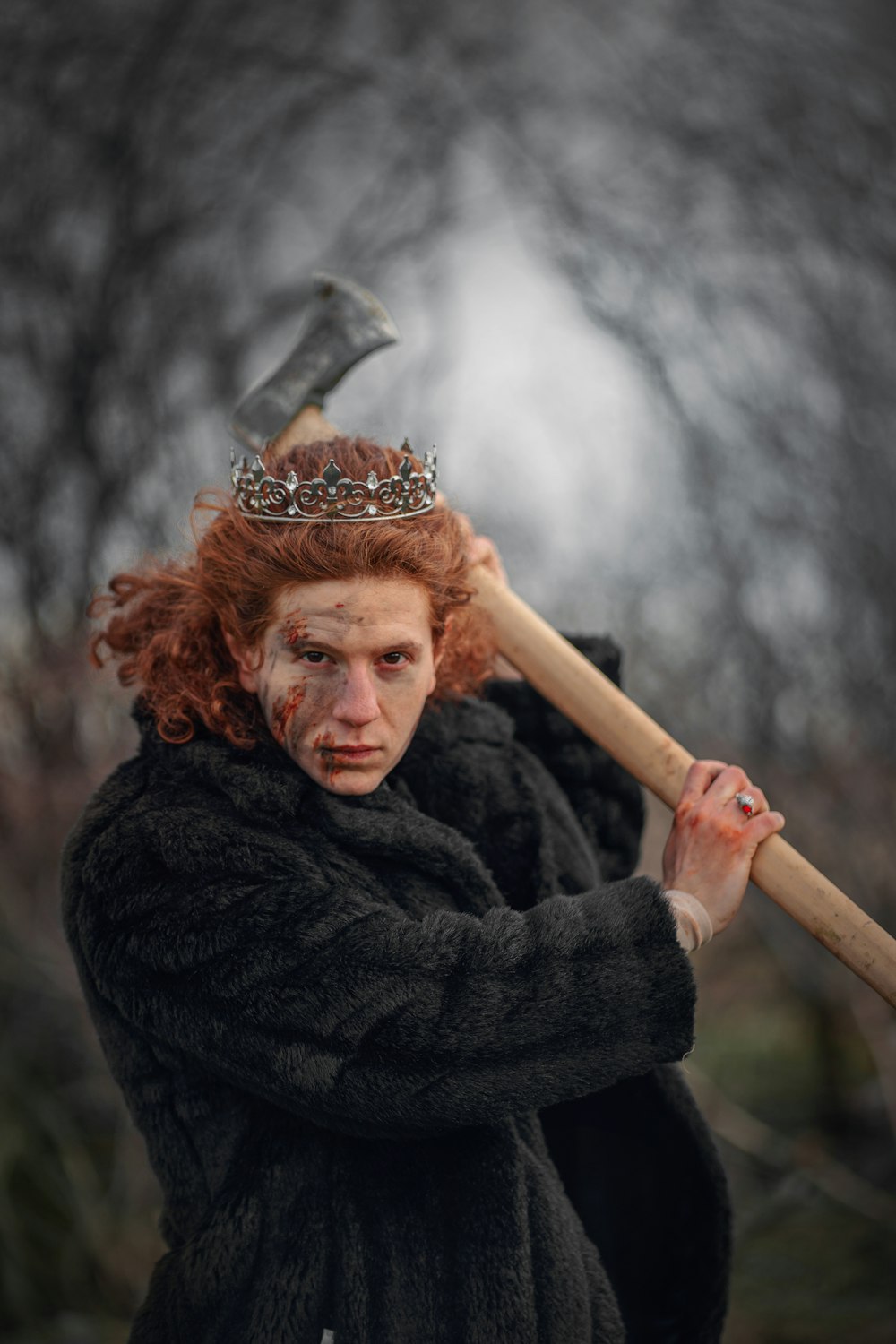 a woman with a crown on her head holding a large axe