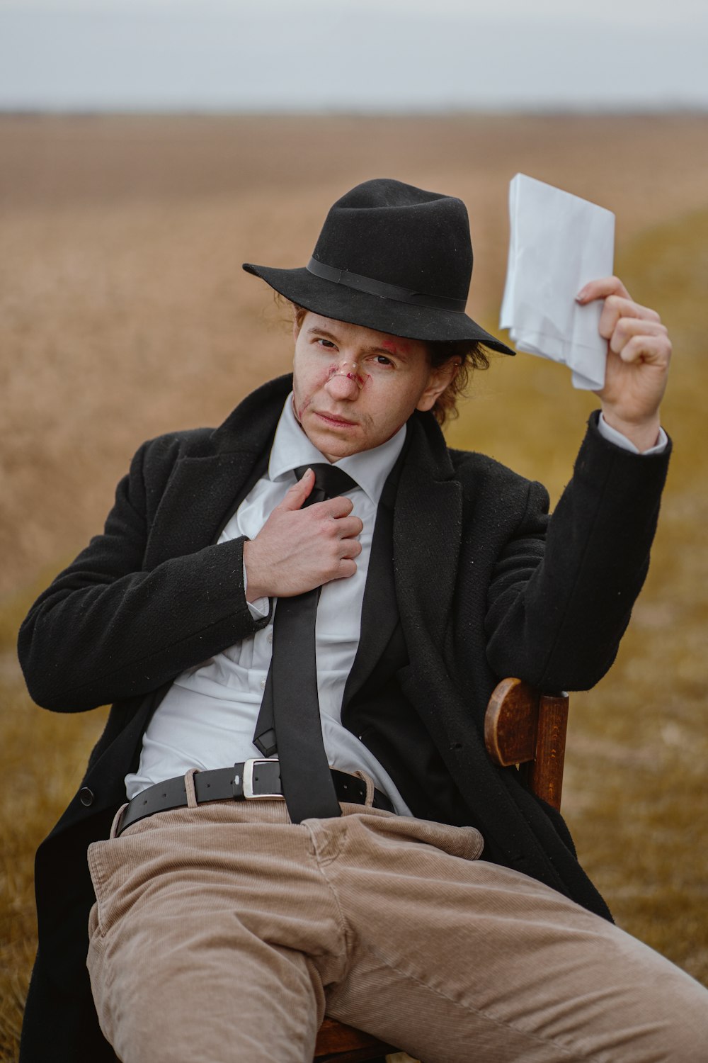 a man sitting in a chair holding a napkin