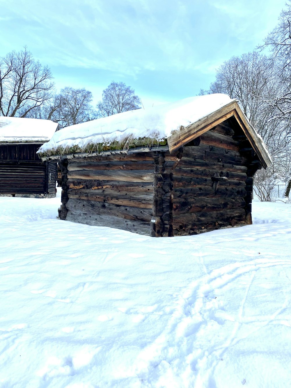 a log cabin in the middle of a snowy field
