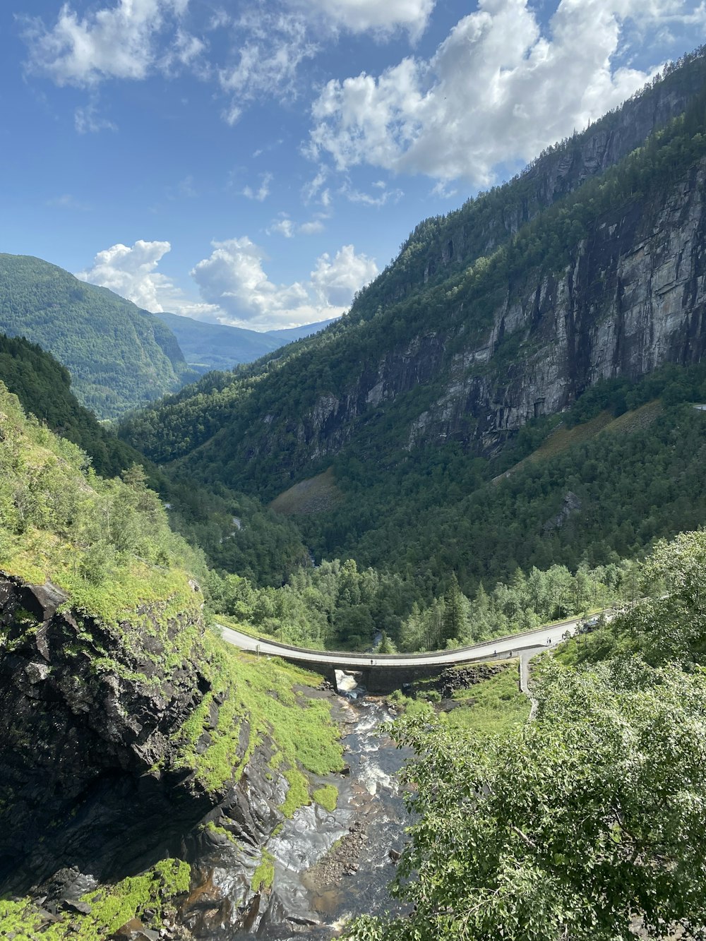 a bridge over a river in the mountains