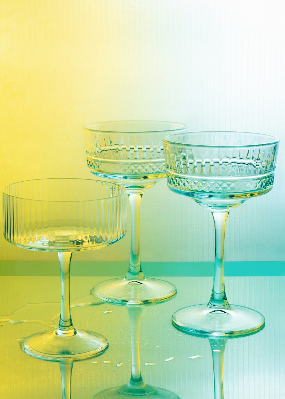 three wine glasses sitting on top of a table